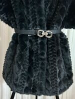 Détail de la ceinture et de la texture du gilet en fausse fourrure noire