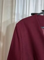 Détail de l’épaule d’une veste tailleur bordeaux