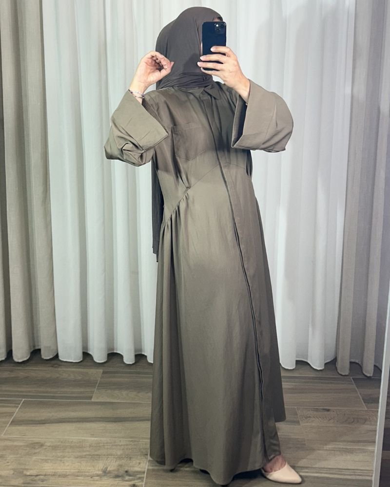 robe-longue-chemise-couleur-taupe Robe longue style chemise couleur taupe avec manches longues évasées, portée de profil.