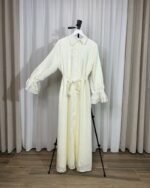 Robe longue fluide pastel sur cintre avec col chemise, boutons avant et manches à poignets élastiqués festonnés.